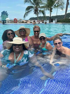 Friends enjoying a sunny day together in a resort pool