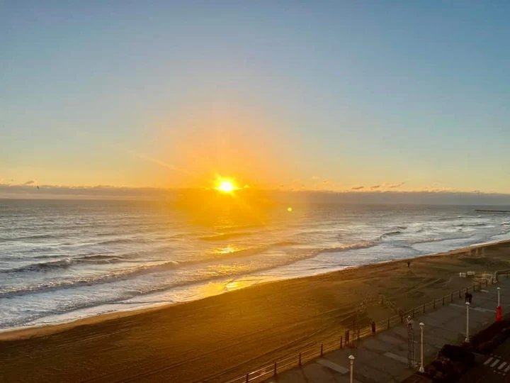 Sunrise glowing over the ocean and shoreline
