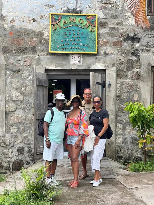 A group of travelers gathered outside a stone entrance