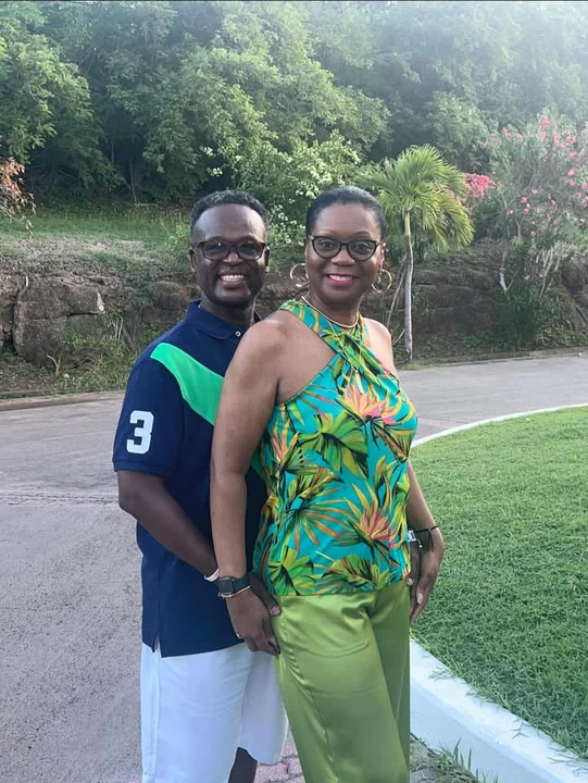 John and Veronica smiling together in a landscaped garden