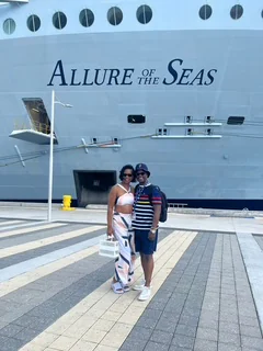 John and Veronica standing together beside the Allure of the Seas