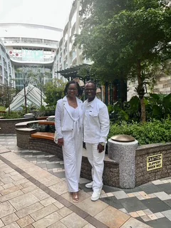 John and Veronica dressed in white beside a cruise ship garden