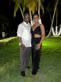 John and Veronica dressed for an evening beneath palm trees