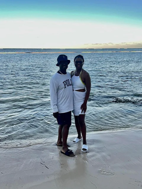 John and Veronica standing together at the shoreline