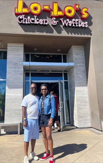 John and Veronica standing outside a restaurant on a sunny day